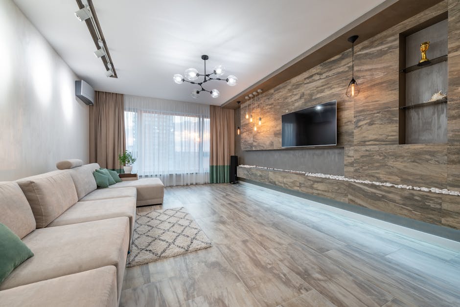 Interior of spacious living room with empty comfortable sofa and TV hanging on wooden wall in contemporary flat