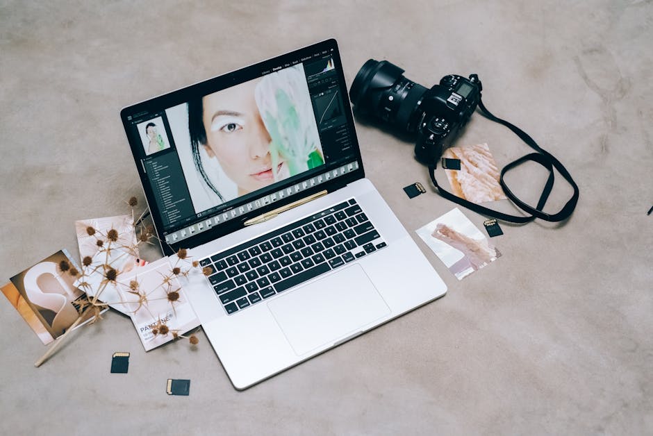 A creative workspace featuring photography equipment and a laptop for digital editing and photo management.