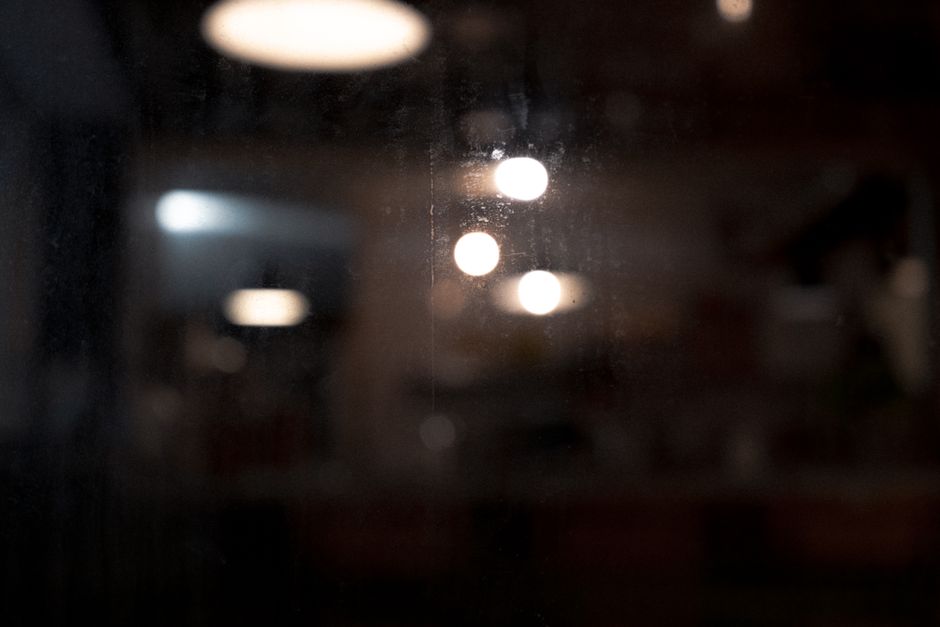 A dark abstract image showcasing blurred bokeh lights with a moody atmosphere.