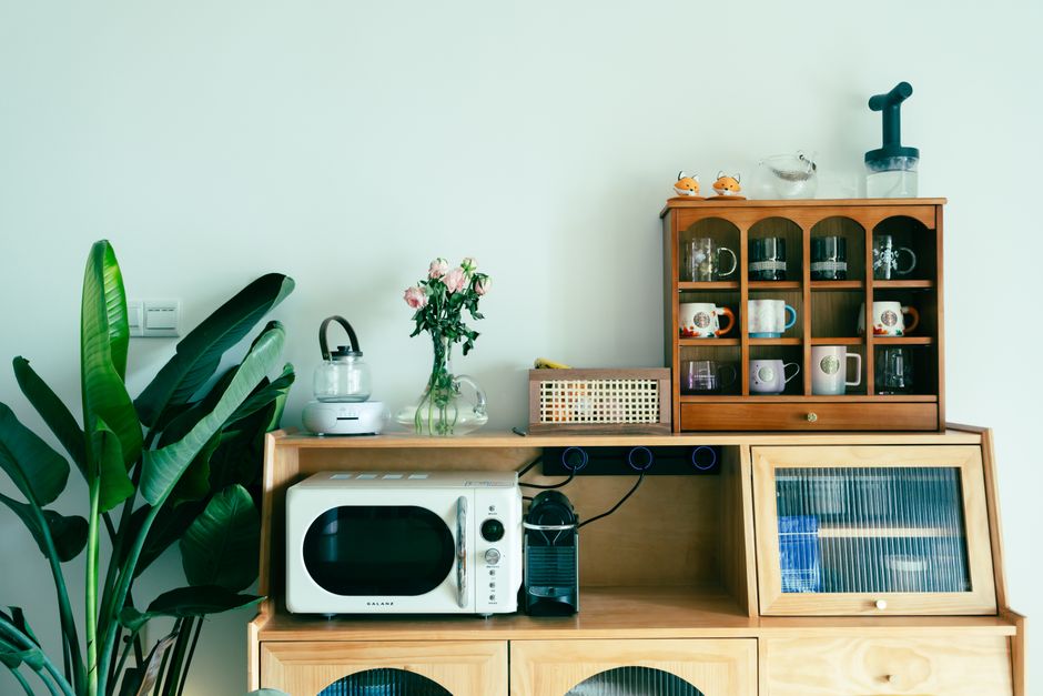 Charming kitchen setup featuring vintage appliances and decor on a wooden dresser.