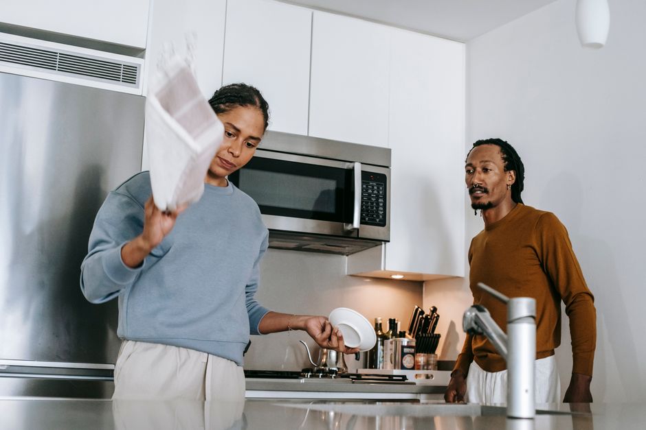 African American couple in casual clothes having conflict while standing at home in daytime