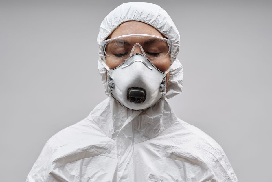 Healthcare professional wearing full protective equipment for safety and protection.