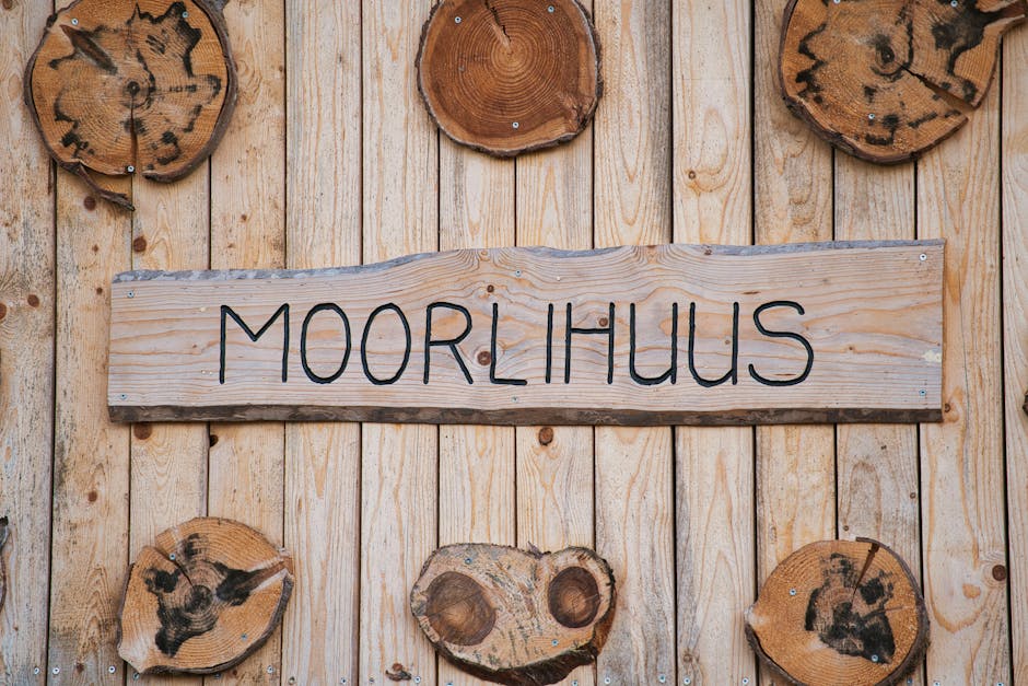 Detailed view of a wooden wall with a prominent Moorlihuus sign and tree cross-sections.
